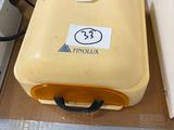 a yellow suitcase sitting on top of a cardboard box