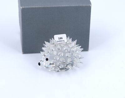 a close up of a small hedge with a box in the background