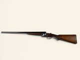 a rifle on a white surface with a white background