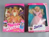 two barbie dolls in the box on the table