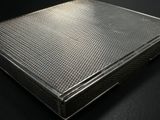 an image of a metal box sitting on top of a black table