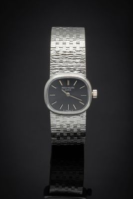a close up of a wrist watch on a black surface