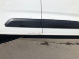 a white car parked in a parking lot with its door open