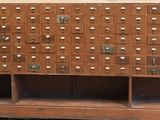 an old wooden cabinet with a lot of holes on it