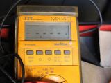 an image of a multimeter with wires connected to it sitting on top of a table