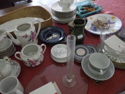 une table rouge sur laquelle sont posés de nombreux plats et tasses