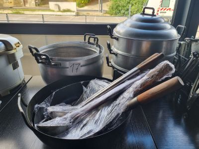 several pots and pans are sitting on a table near a window