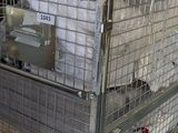 a large metal cage with a mattress inside of it