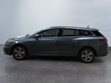 the grey car is parked in a room with a white wall
