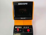 a small electronic game on a white surface