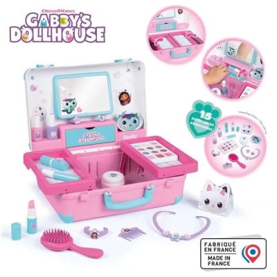 une maison de poupées avec un coffret rose et divers accessoires