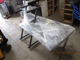 a picture of a workbench in a garage with plastic wrap