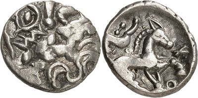 a silver coin with a horse and rider on it