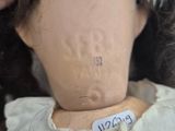 a doll that has a tag on it ' s head