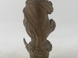 an antique statue of a man sitting on top of a flower pot