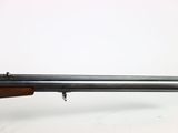 a rifle on a stand with a white background