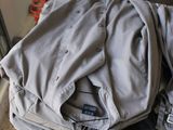 a pile of clothes sitting on a table in a room