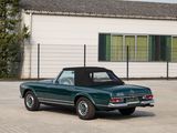 a green convertible car parked in front of a white building