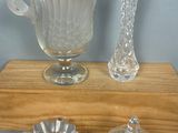 three glass vases sitting on a wooden shelf next to each other