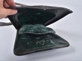 a person opening a wallet with a key in it