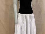 the mannequin is wearing a black top and white skirt