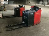 two forklifts that are sitting in a warehouse