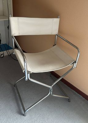 a white chair that is sitting in the corner of a room