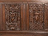 carvings on the side of a wooden cabinet with carvings on the doors