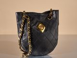 black quilted purse with gold hardware and chain strap