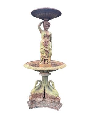 a statue of a woman holding an umbrella on top of a fountain