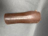 a brown leather object on a gray surface