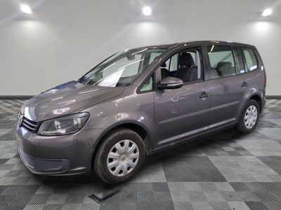 the small grey van is parked in the garage on a checkered floor
