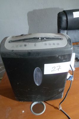 a black and silver toaster sitting on a wooden table
