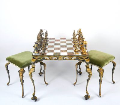 an image of a chess table with two stools and a chess board on it