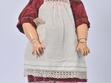 an image of a doll with a red hat and white dress