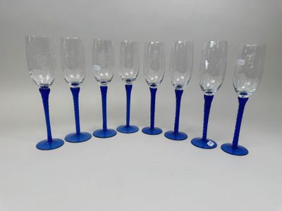 six blue wine glasses lined up on top of each other