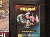 two boxes of warhammer miniatures sit next to each other on a table