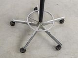 an image of a metal table with wheels on it