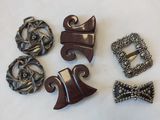 five different pieces of jewelry on a white surface