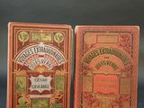 two small books sitting on top of a table next to each other