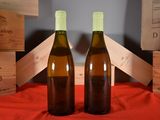 two bottles of wine sitting next to each other on a table