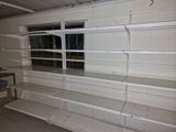 a empty shelf in the middle of a room with a window