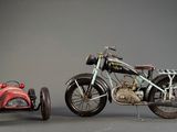 a small toy motorcycle next to a small toy car