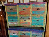 a wooden dresser with many drawers and a bench