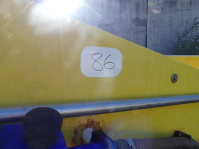 a close up of a yellow boat with a sticker on it ' s side