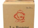 boxes stacked on top of each other with a bottle of wine on top of them