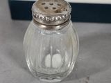 a salt and pepper shaker sitting on a table