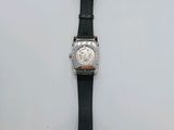 a watch that is laying on a white surface