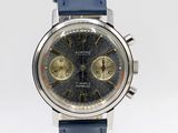 a close up of a wrist watch with a blue strap