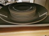 a stack of plates sitting on top of a stove